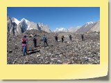 17. Trekkers walking across Baltoro Glacier on their way to Urdukas camp